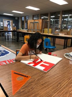 freshman Lilianna Cortez in art completing the last of the square canvas